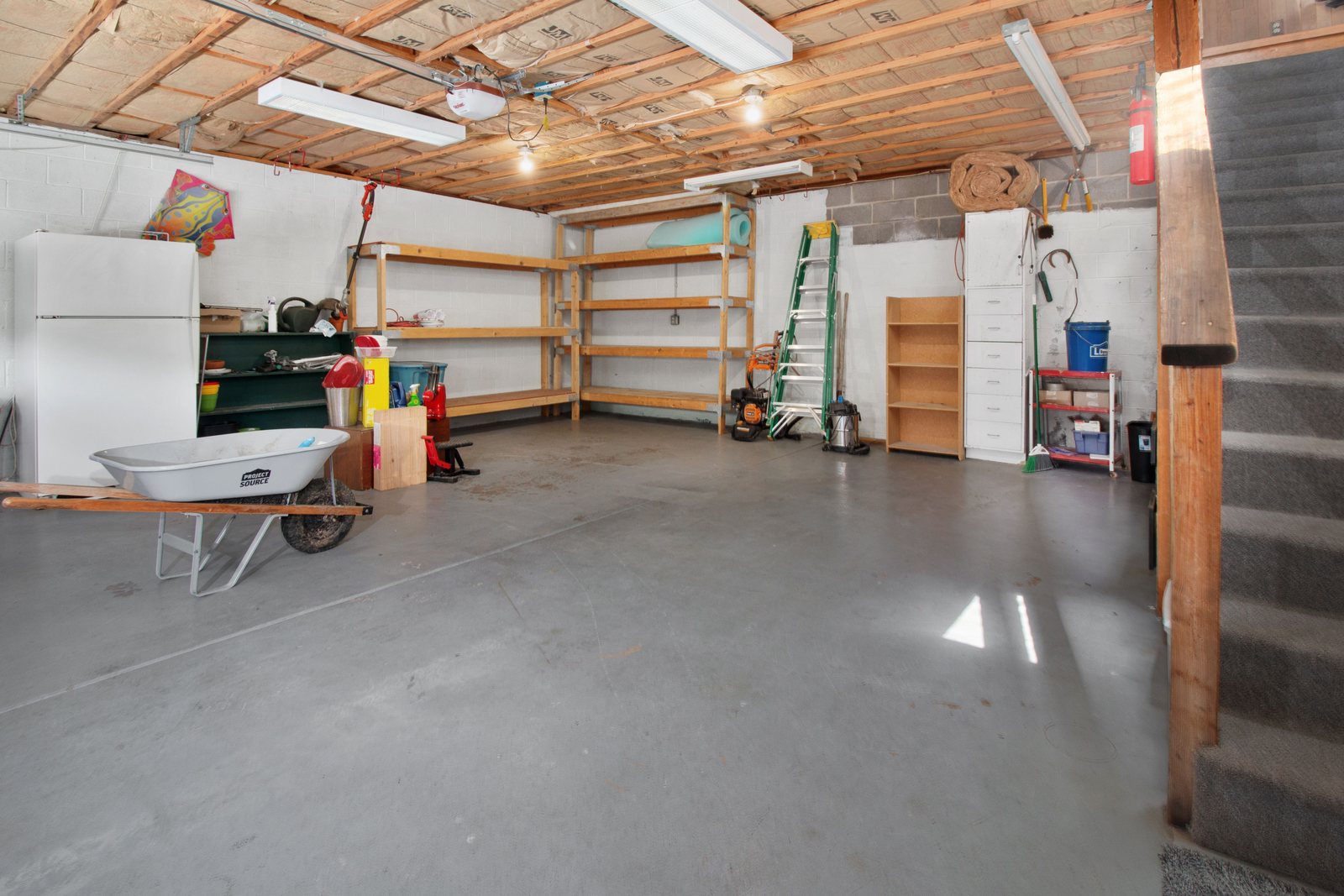 Clean concrete driveway leading to a residential garage